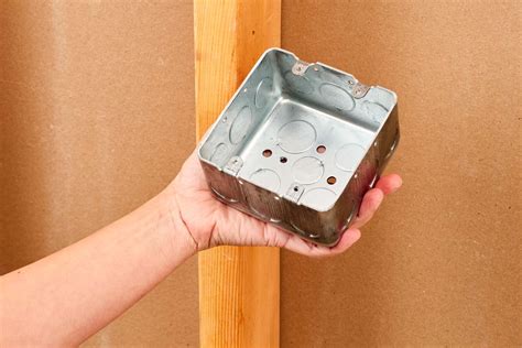 how to open holes in round non metallic electrical box|removing electrical box knockouts.